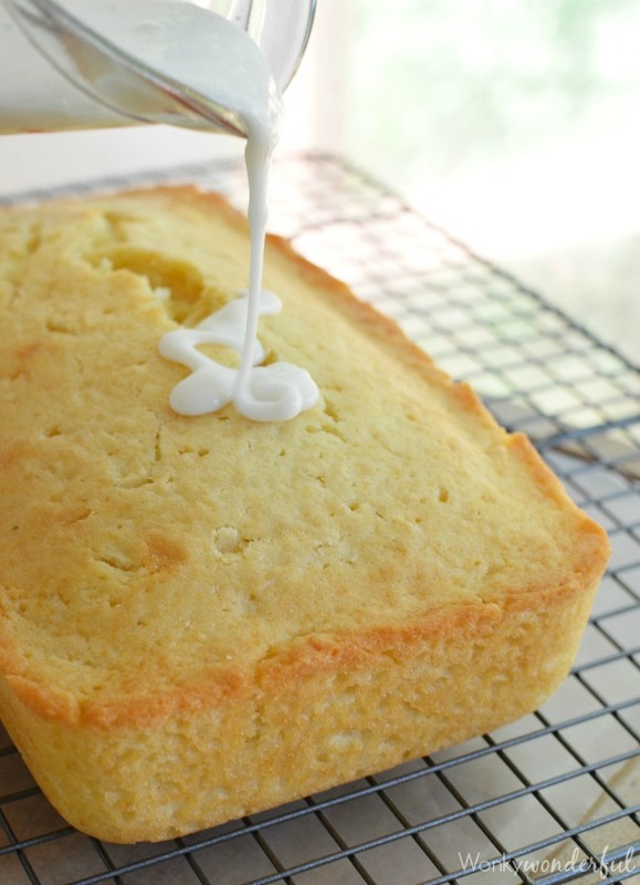 white glaze being poured over yellow loaf
