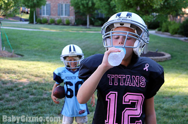 little football players drinking water