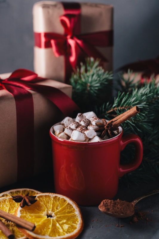 Hot chocolate or cocoa with marshmallows on gray background. Christmas presents. Holiday concept.