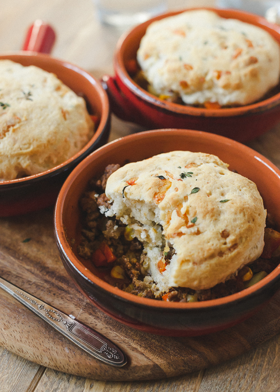 A serving of Biscuit Topped Shepherd's Pie with one bite missing.