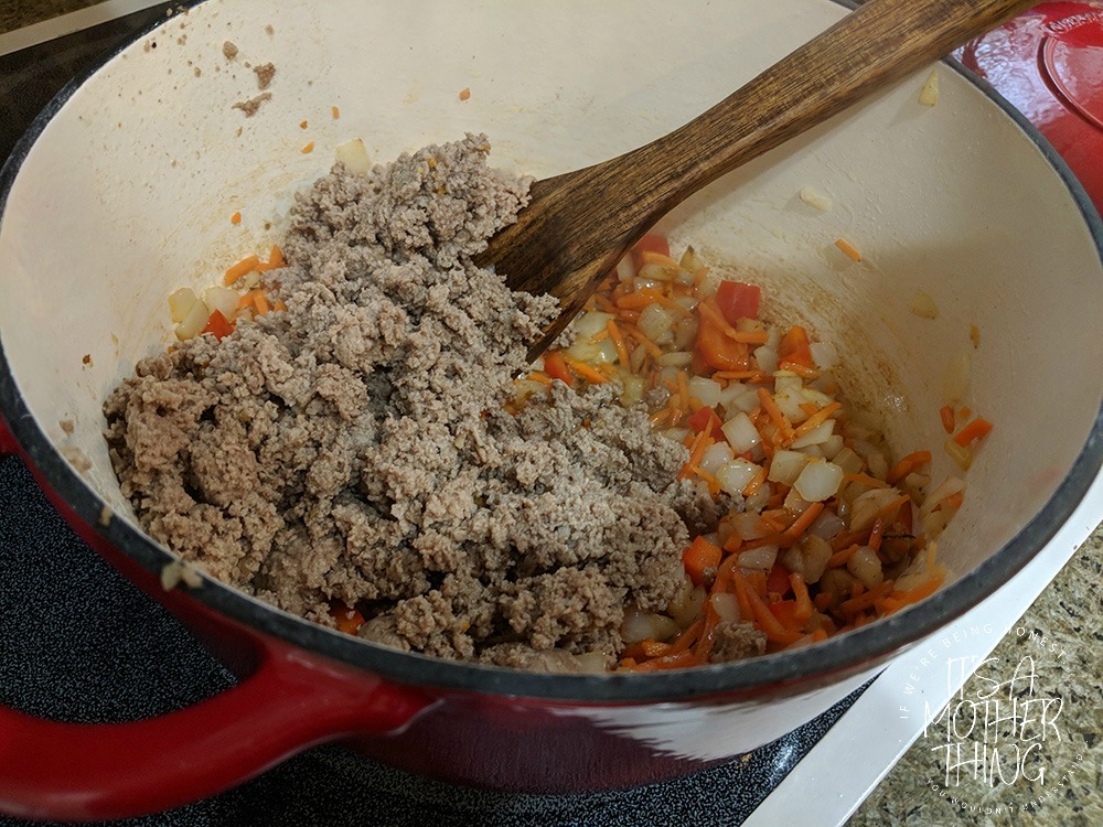 adding meat into a pot