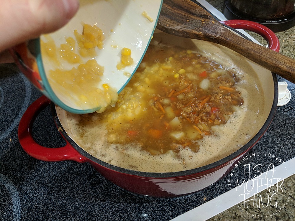 adding corn into a soup