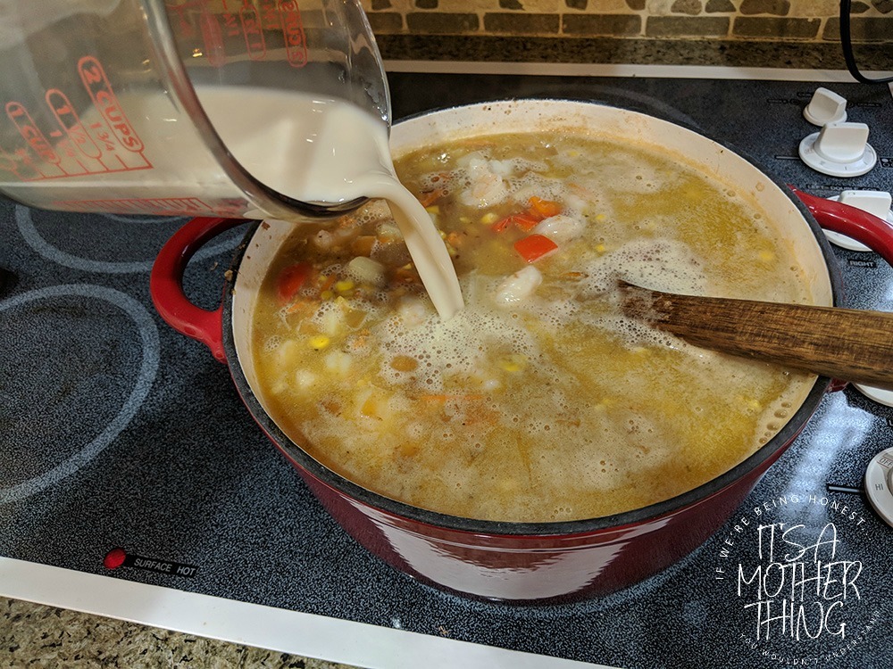 adding almondmilk into a soup