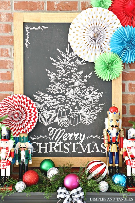 merry christmas chalkboard, paper fan decorations, christmas mantel, nutcrackers